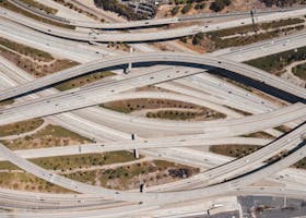 Aerial shot of sprawling highway interchange in Los Angeles with sparse traffic.